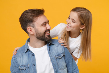 Funny bearded man in casual clothes have fun with cute child baby girl. Father little kid daughter isolated on yellow background. Love family day parenthood childhood concept. Looking at each other.