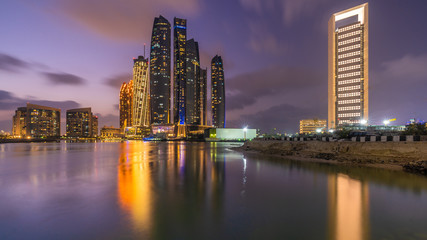 Fototapeta na wymiar Jumeirah at Etihad Towers , Abu Dhabi Skyline at sunset