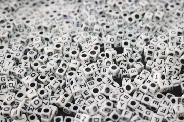 abstract image of white dice, cubes with letters