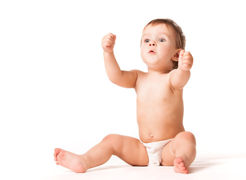Close up of cute happy child placing hands on ears. Joyful infant kid looking aside and smiling. Isolated on white studio background. Concept of childhood.