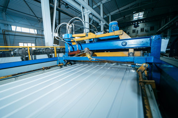 Production of metal professional flooring and panels. Cutting machine close up