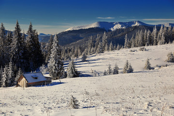 lonely shelter with mountains on background in winter