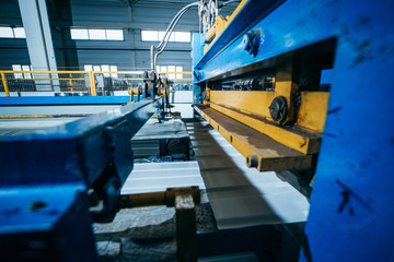 Production of metal professional flooring and panels. Cutting machine close up