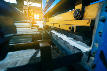 Production of metal professional flooring and panels. Cutting machine close up