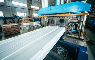 Production of metal professional flooring and panels. Cutting machine close up