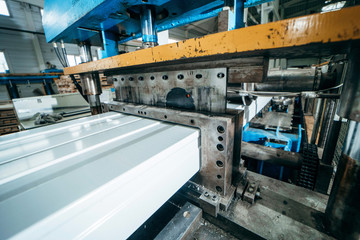 Production of metal professional flooring and panels. Cutting machine close up