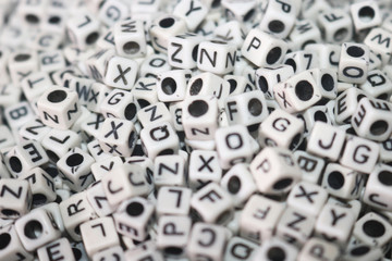 white dice/cubes on letters