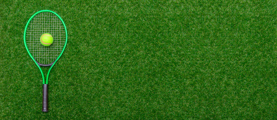 Top view of tennis racket and ball of green grass. Horizontal sport poster, greeting cards, headers, website