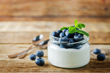 Greek yogurt blueberry parfaits with fresh berries and mint leaves