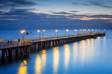 Fototapeta na wymiar Beautiful landscape with wooden pier in Gdynia Orlowo at sunrise, Poland