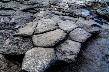 Black rock formations the phenomenon of nature from the frozen lava in the form of pentagons. 