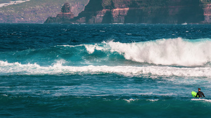 Beautiful Surfer spot with big waves surrounded by high cliffs