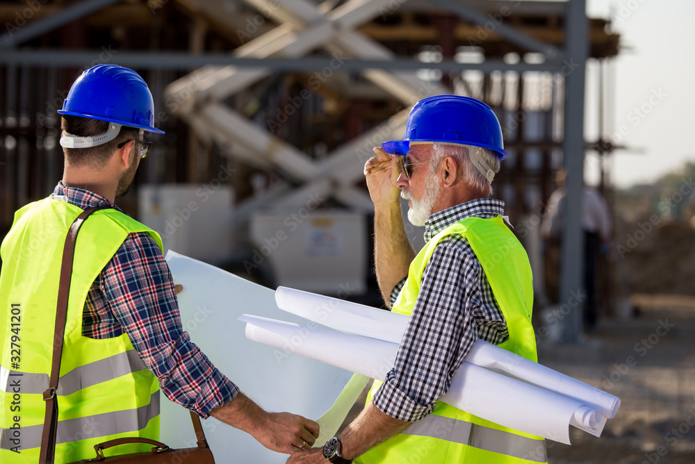 Wall mural Engineers at construction site