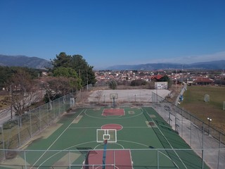 Fototapeta premium Aerial drone shot over a basketball court in a sports complex in Choristi,Drama,Greece