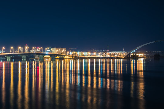 Havana bridge in Kiev at night with colorful illumination and reflection in Dnipro river