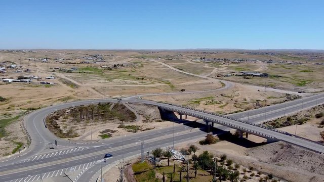 Flight over the highway with overpass in desert at south of Israel