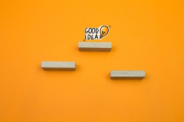 Business good idea achievement concept, leadership idea, first place prize victory, competition winner on the orange background with copy space. Wooden blocks