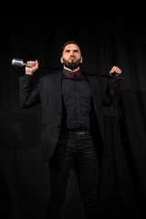 Obraz na płótnie Canvas Serious male singer with microphone on black
