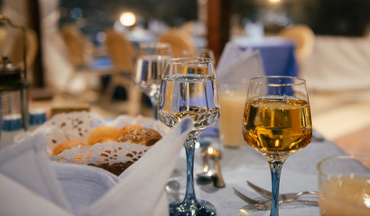Glasses of wine and water on a table in a restaurant