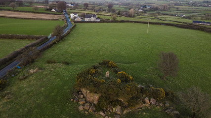 Drone image of The Holestone, ancient Bronze age standing stone that sits atop a small rocky outcrop outside Doagh, County Antrim, Northern Ireland