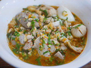 Close up of tasty spicy noodle pork soup ( Guay Tiao Tom Yum Moo ) - delicious and healthy street food in Thailand