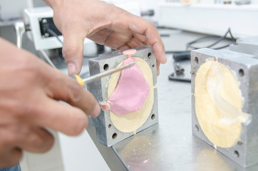 Fototapeta premium Dental laboratory, acrylic injection and polishing work for dental prostheses