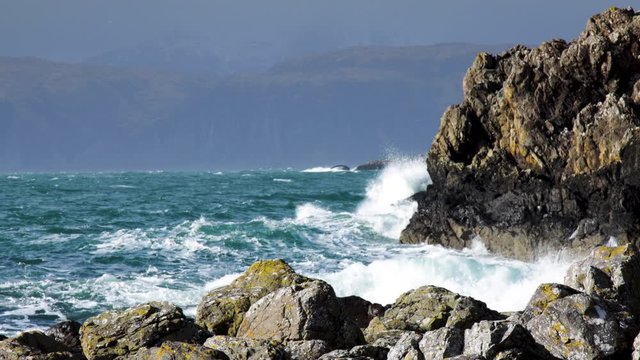 footage of the atlantic ocean as it meets the Isle of Seil on the west coast of scotland in the argyll and kintyre region showing waves pounding on the shore