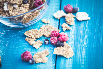 Cereal and forest berries on wooden background
