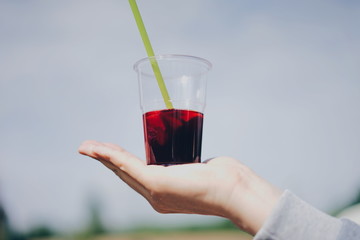 hand holding a drink