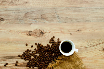 Coffee cup with coffee bag on wooden table. View from top.