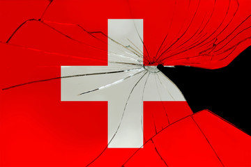 broken mirror on the background of the national silk flag of the state of switzerland, concept of state problems