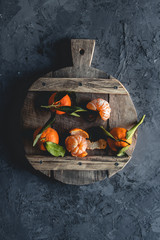 Fresh orange mandarin on wooden cutting board. eco vegetarian. PNOV2019