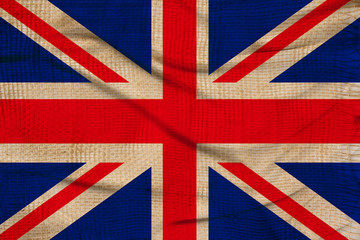 photo of the beautiful colored national flag of the modern state of Great Britain on textured fabric, concept of tourism, emigration, economics and politics, closeup