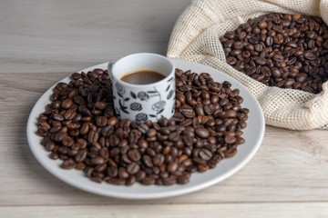 Coffee on plate and cup seen from above ready to drink