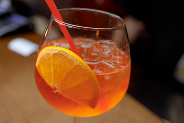 orange juice in glass on wooden table