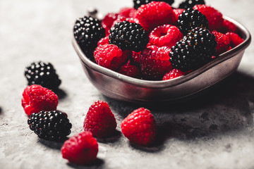 Fresh berries raspberries, blackberries on a gray art background. Healthy food, summer berries