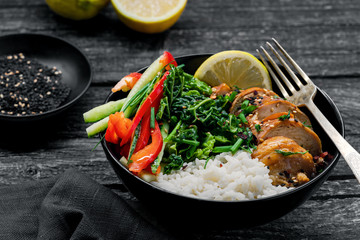eriyaki chicken fillet, fresh cucumber, red bell pepper, stew cabbage and basmati rice Traditional Asian Buddha bowl meal.
