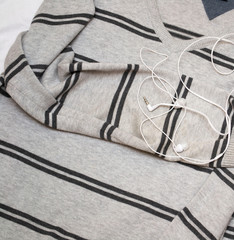 headphones on a striped gray jumper