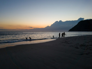 In the summer watching the sunset at Itacoatiara beach, Niteroi city, Rio de Janeiro State, Brazil.