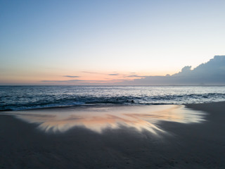 Fototapeta premium In the summer watching the sunset at Itacoatiara beach, Niteroi city, Rio de Janeiro State, Brazil.