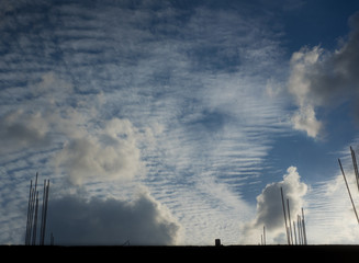 white clouds on a blue sky, city view