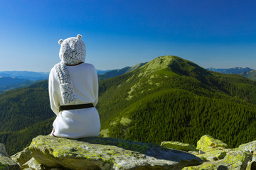 travel life stile landscape concept photography woman sitting back to camera on edge of cliff top...