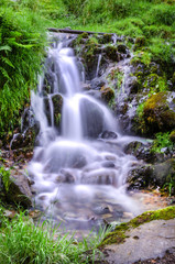 A shot of a waterfall flowing down the hillside in the lake district showing the water movement