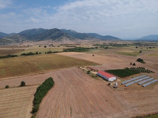 Obraz premium Aerial drone landscape photo from high above of fields in a clear weather summer day in the outskirts of Drama, Greece