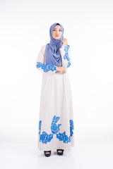 Full length portrait of a beautiful female model wearing jubah dress and hijab, a lifestyle apparel for Muslim women isolated on white background. Beauty and hijab fashion concept.