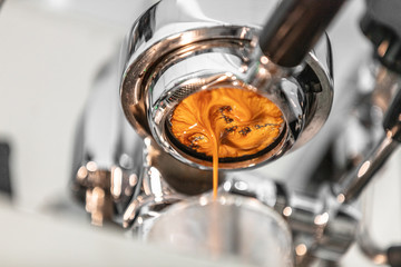 Coffee machine espresso extraction pouring from bottomless naked portafilter. Professional...