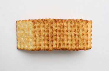 Toasted delicious square cookies laying in row close up