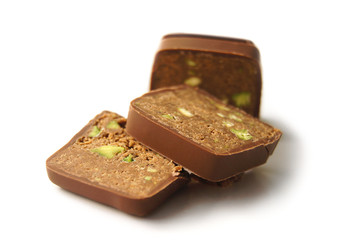 Delicious fresh chocolate slices with pistachio on white background