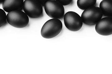 Composition of black easter eggs on a white background. Easter minimalistic concept