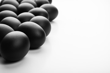 Composition of black easter eggs on a white background. Easter minimalistic concept